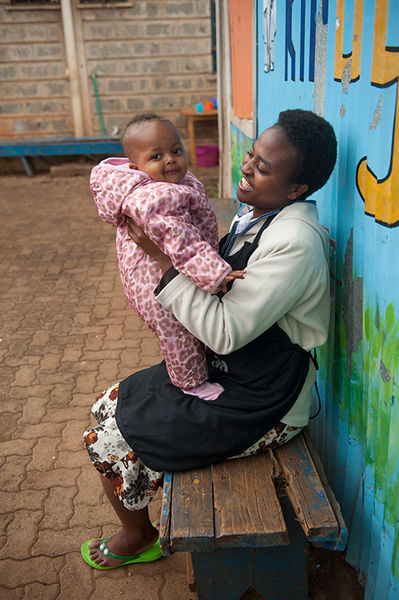 Child with worker at the Kidogo Center in Nairobi, Kenya