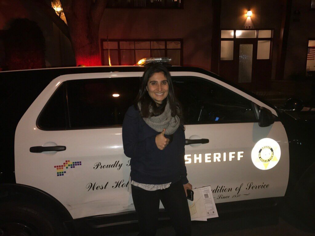 Senior program officer Andrea Iloulian in front of a West Hollywood squad car.